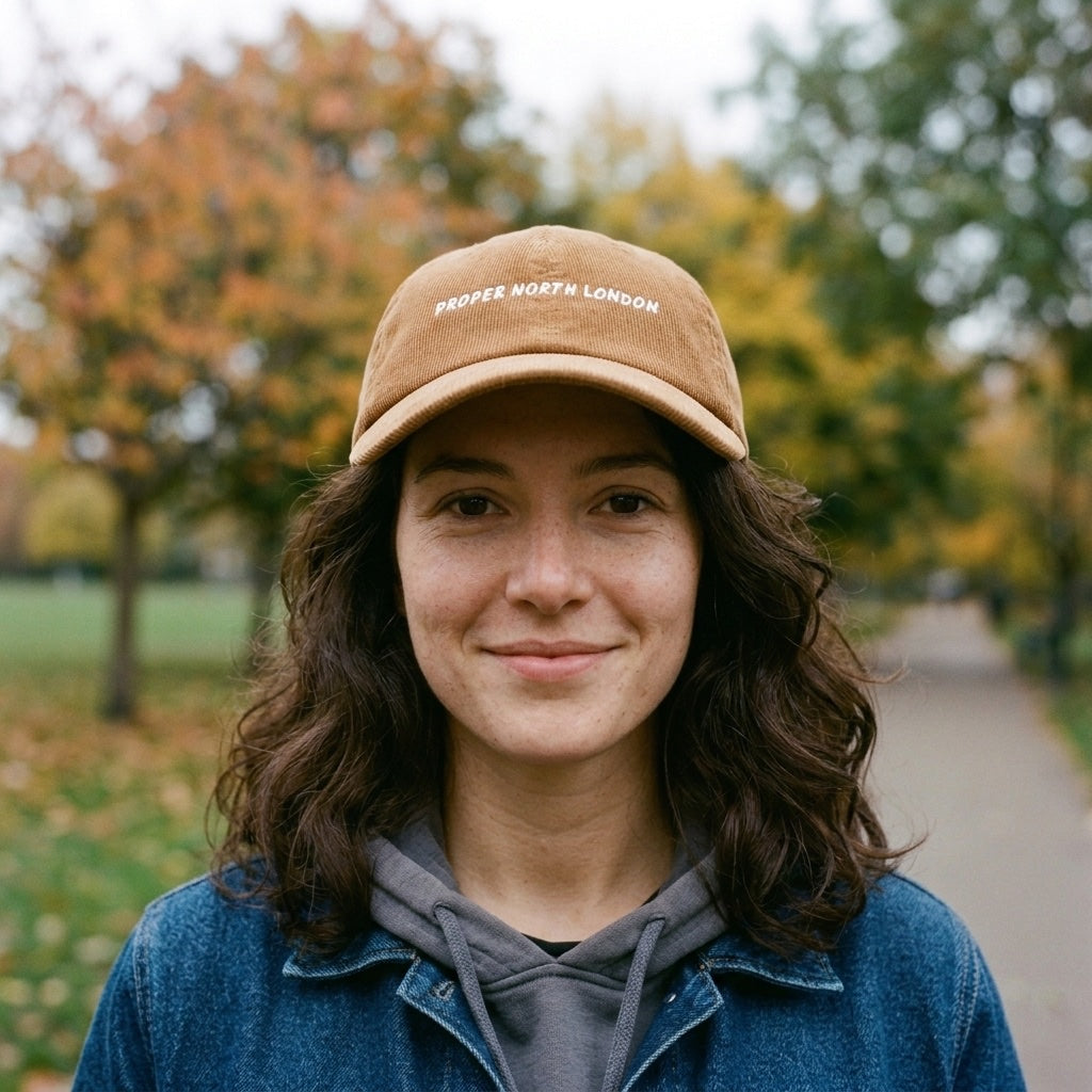 Woman wearing the Proper North London corduroy cap in Camel on Highbury Fields, Islington, North London
