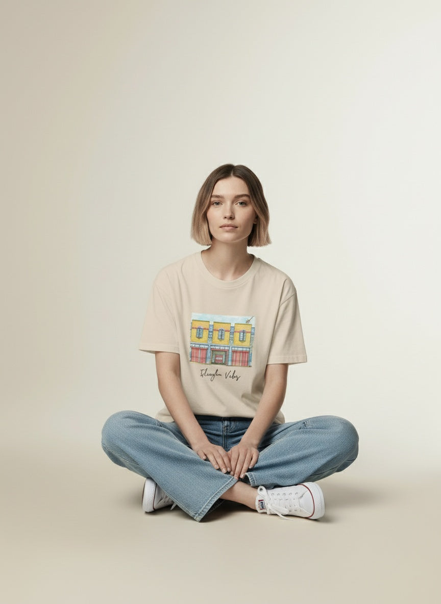 Model sitting while wearing The Fire Station Tee